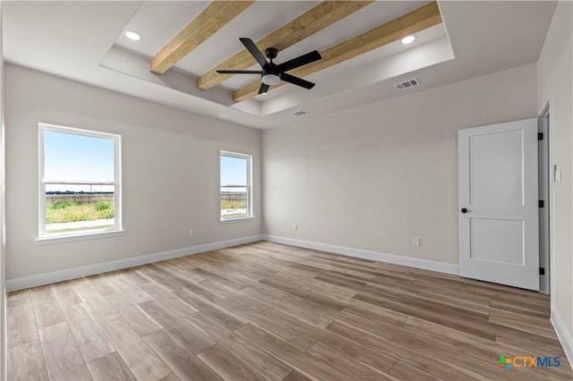 1811 Ember Dr, Temple, TX 76502 - empty room with a raised ceiling, wood finished floors, beam ceiling, a ceiling fan, and recessed lighting