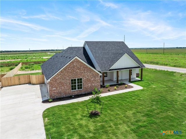 1811 Ember Dr, Temple, TX 76502 - view of front of property with roof with shingles, brick siding, a rural view, and driveway