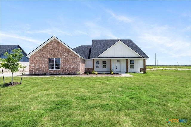 1811 Ember Dr, Temple, TX 76502 - modern inspired farmhouse with board and batten siding, a front lawn, brick siding, and roof with shingles