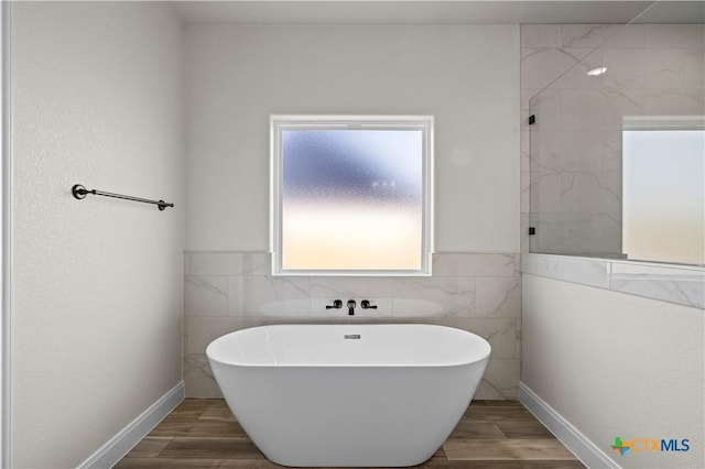 1811 Ember Dr, Temple, TX 76502 - bathroom featuring a freestanding bath, tile walls, wood finished floors, and tiled shower