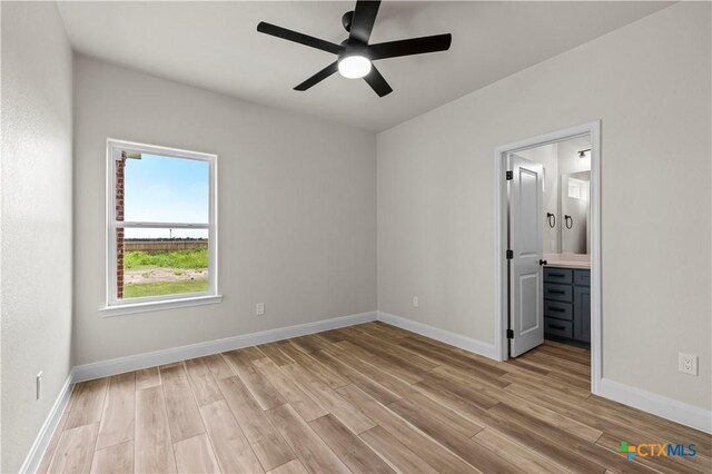 1811 Ember Dr, Temple, TX 76502 - unfurnished bedroom featuring light wood finished floors, connected bathroom, and a ceiling fan