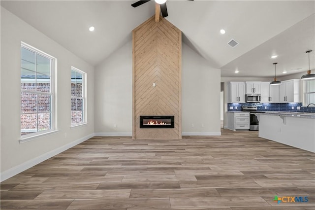 1811 Ember Dr, Temple, TX 76502 - unfurnished living room with high vaulted ceiling, a ceiling fan, healthy amount of natural light, recessed lighting, and a fireplace