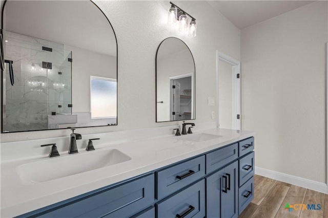 1811 Ember Dr, Temple, TX 76502 - full bath featuring a shower stall, double vanity, and wood finished floors
