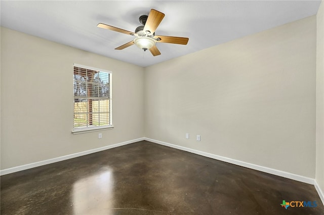 empty room featuring concrete flooring, ceiling fan, and baseboards