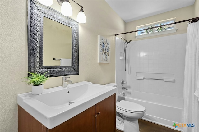 bathroom with a textured wall, shower / bathtub combination with curtain, toilet, and vanity