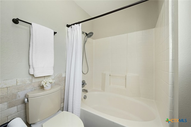 bathroom with shower / bathtub combination with curtain and toilet