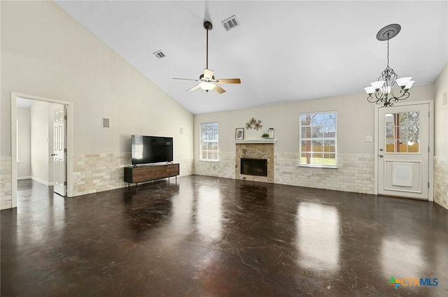 unfurnished living room with a healthy amount of sunlight, a fireplace, visible vents, and concrete flooring