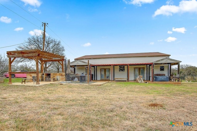 back of property featuring french doors, a patio, a yard, and a pergola