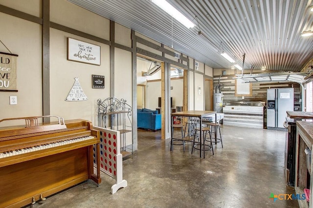 interior space featuring water heater and finished concrete flooring