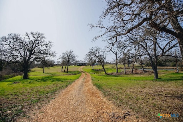 view of property's community with a lawn and driveway