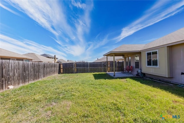 view of yard featuring a patio area and a fenced backyard