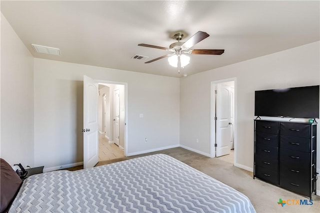 bedroom with light carpet, visible vents, a ceiling fan, and baseboards