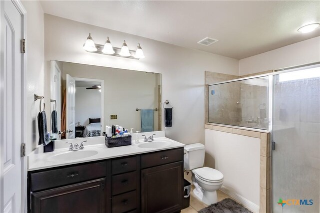 ensuite bathroom featuring a stall shower, visible vents, ensuite bathroom, and a sink