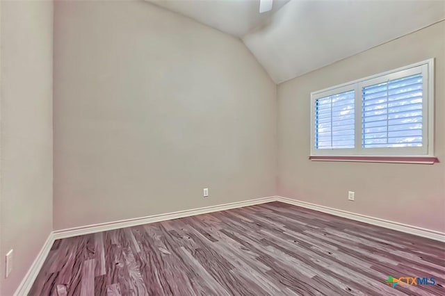 empty room with lofted ceiling and hardwood / wood-style floors