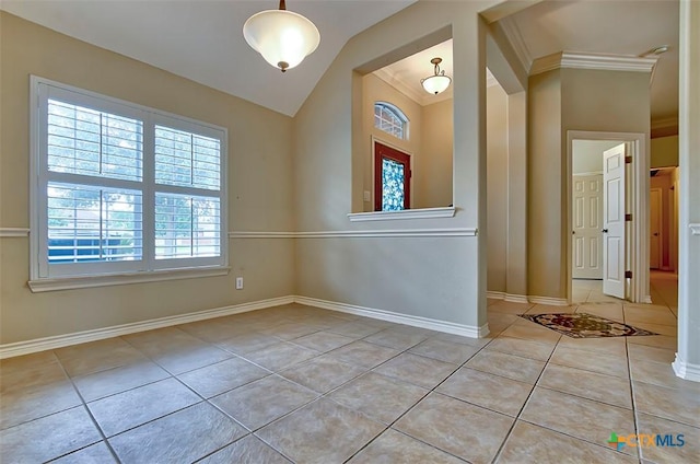 tiled spare room with crown molding and vaulted ceiling