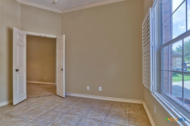 empty room with light tile patterned floors and ornamental molding