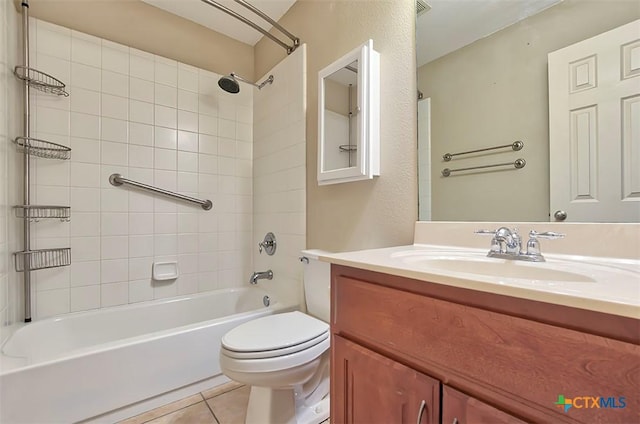 full bathroom with toilet, vanity, tile patterned floors, and tiled shower / bath