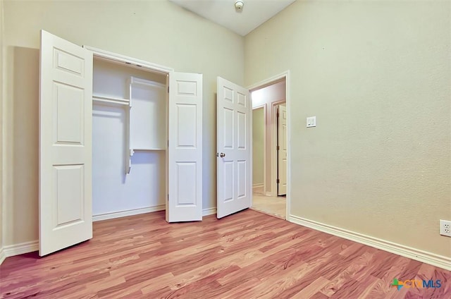 unfurnished bedroom featuring a closet and light wood-type flooring