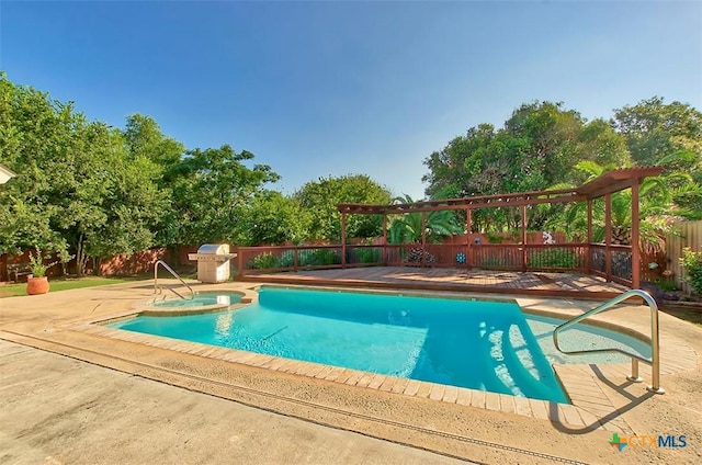 view of swimming pool with a patio area, an in ground hot tub, and a grill