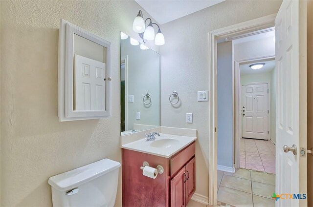 bathroom with tile patterned floors, vanity, and toilet