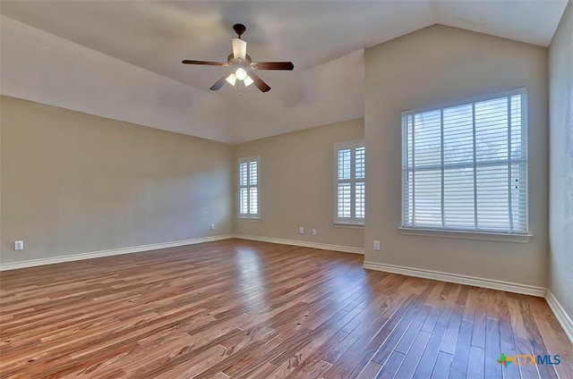 unfurnished room with ceiling fan, hardwood / wood-style floors, and vaulted ceiling