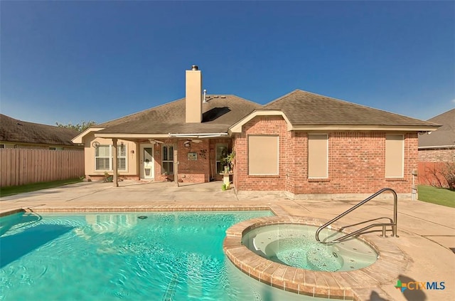 view of pool with a patio and an in ground hot tub