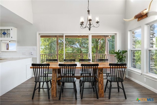 514 Eden Ranch Dr, Canyon Lake, TX 78133 - dining space featuring a chandelier, dark wood-style flooring, and a high ceiling