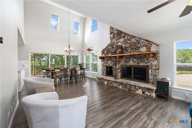 514 Eden Ranch Dr, Canyon Lake, TX 78133 - living room featuring a ceiling fan, a fireplace, a chandelier, wood finished floors, and high vaulted ceiling
