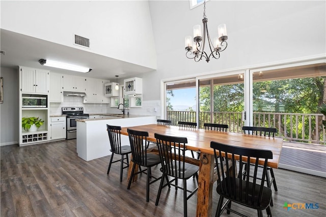514 Eden Ranch Dr, Canyon Lake, TX 78133 - dining area featuring a high ceiling, a chandelier, and dark wood-style floors