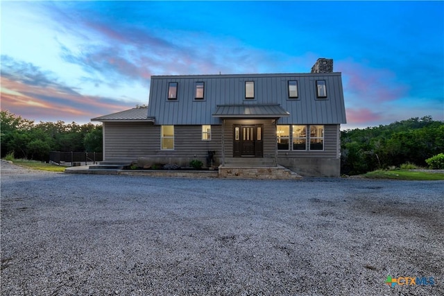 514 Eden Ranch Dr, Canyon Lake, TX 78133 - view of front of home with a chimney, a metal roof, and a standing seam roof