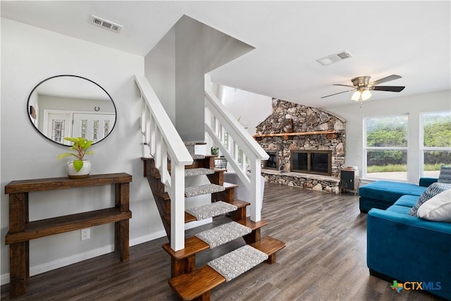 514 Eden Ranch Dr, Canyon Lake, TX 78133 - stairway with wood finished floors, a ceiling fan, and a stone fireplace