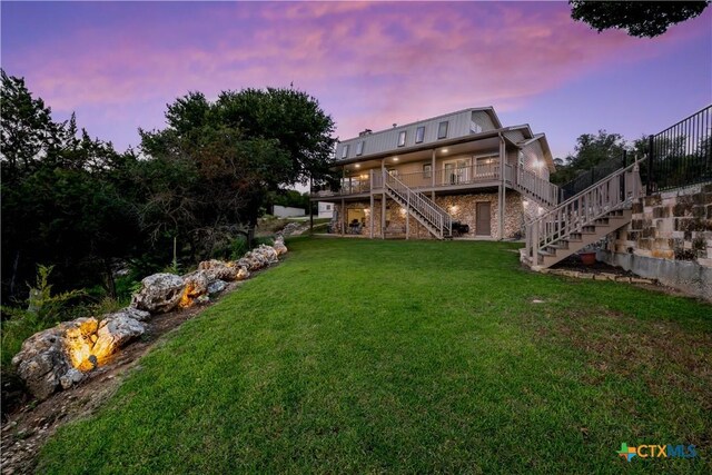 514 Eden Ranch Dr, Canyon Lake, TX 78133 - yard at dusk with stairway, a yard, and a wooden deck