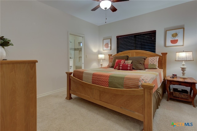 carpeted bedroom with ceiling fan and ensuite bath