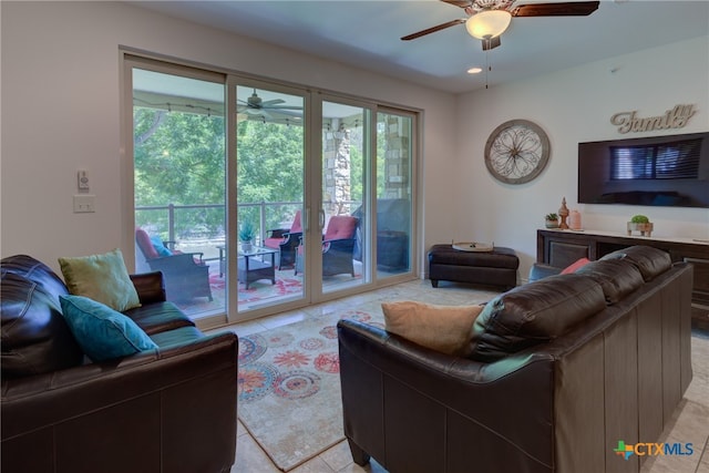 living room with ceiling fan and light tile patterned floors