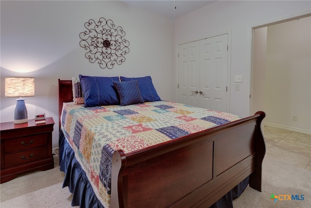 bedroom featuring a closet and light colored carpet