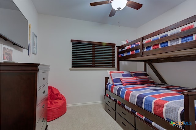 bedroom with light carpet and ceiling fan