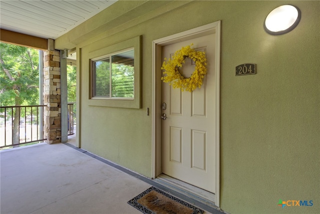 property entrance with covered porch