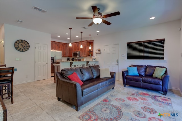 tiled living room featuring ceiling fan