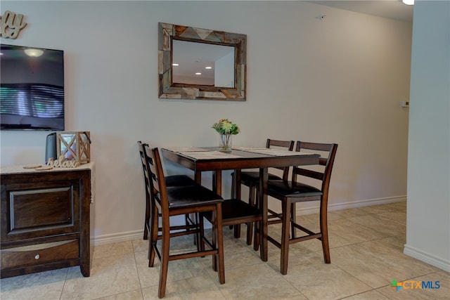 dining space featuring light tile patterned floors