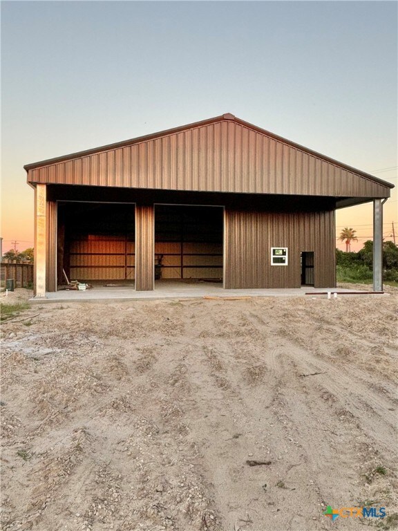 view of garage at dusk