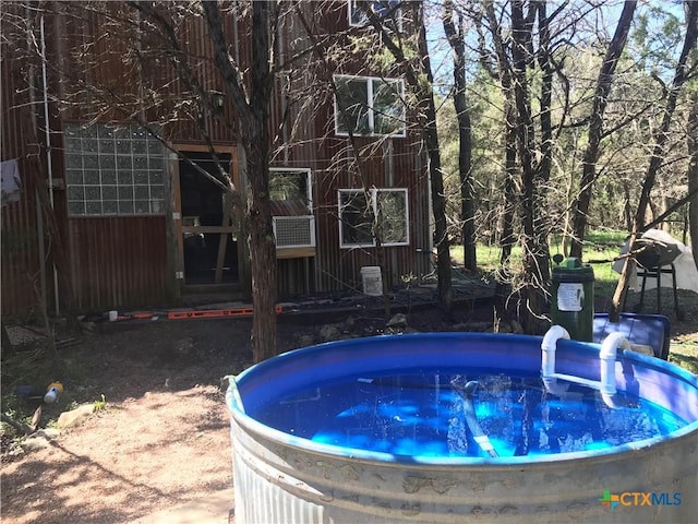 view of swimming pool featuring a hot tub