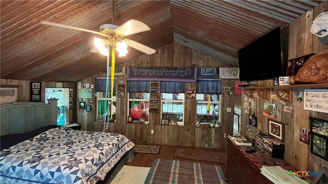bedroom with wood walls, a fireplace, vaulted ceiling, and wood finished floors