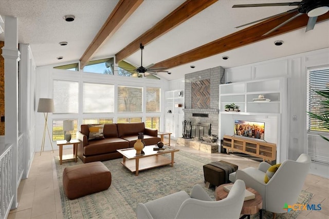 living room featuring built in features, ceiling fan, vaulted ceiling with beams, a fireplace, and a textured ceiling