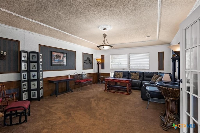 living room featuring carpet flooring and a textured ceiling