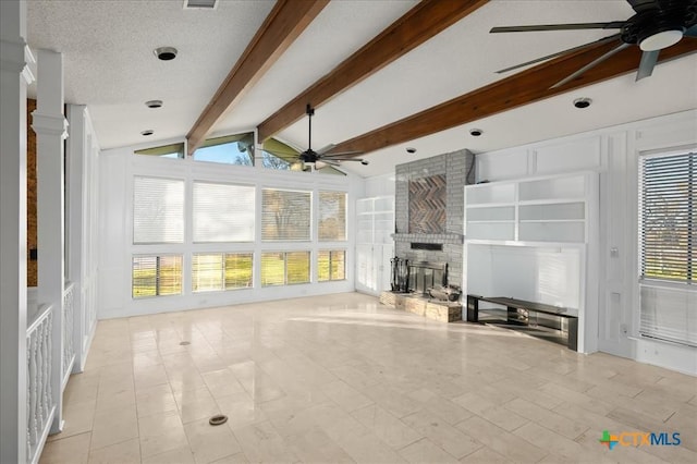 unfurnished living room featuring lofted ceiling with beams, a textured ceiling, a brick fireplace, built in features, and ceiling fan