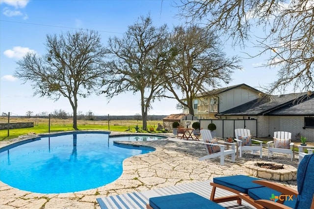 view of pool featuring an in ground hot tub, a patio area, and a fire pit