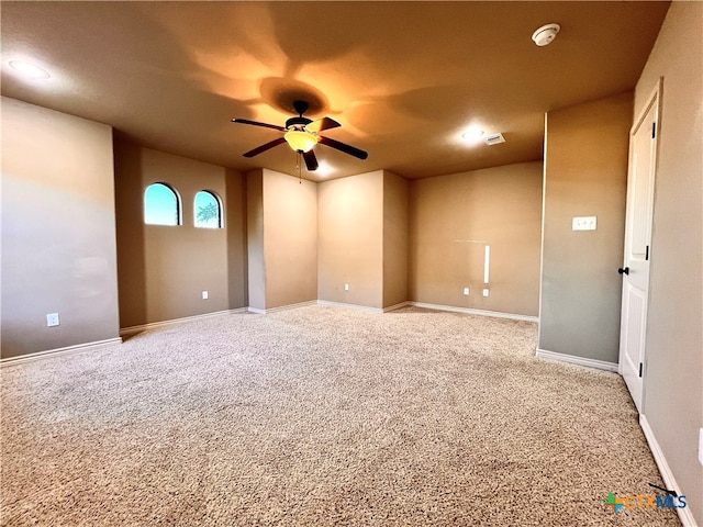 unfurnished room with light colored carpet and ceiling fan