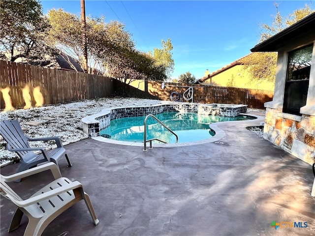 snow covered pool with a patio area