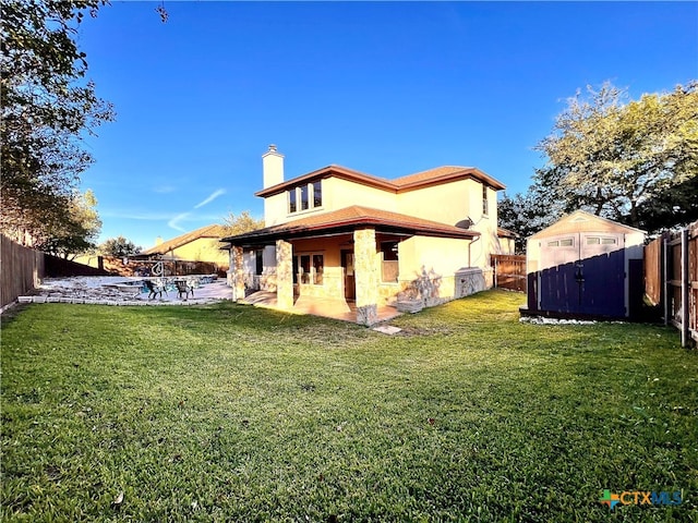 rear view of house featuring a lawn and a patio area