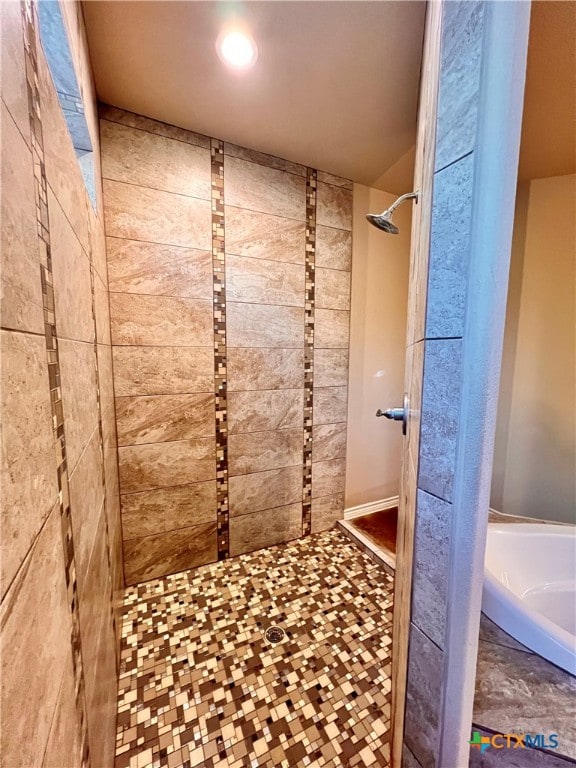 bathroom with tiled shower